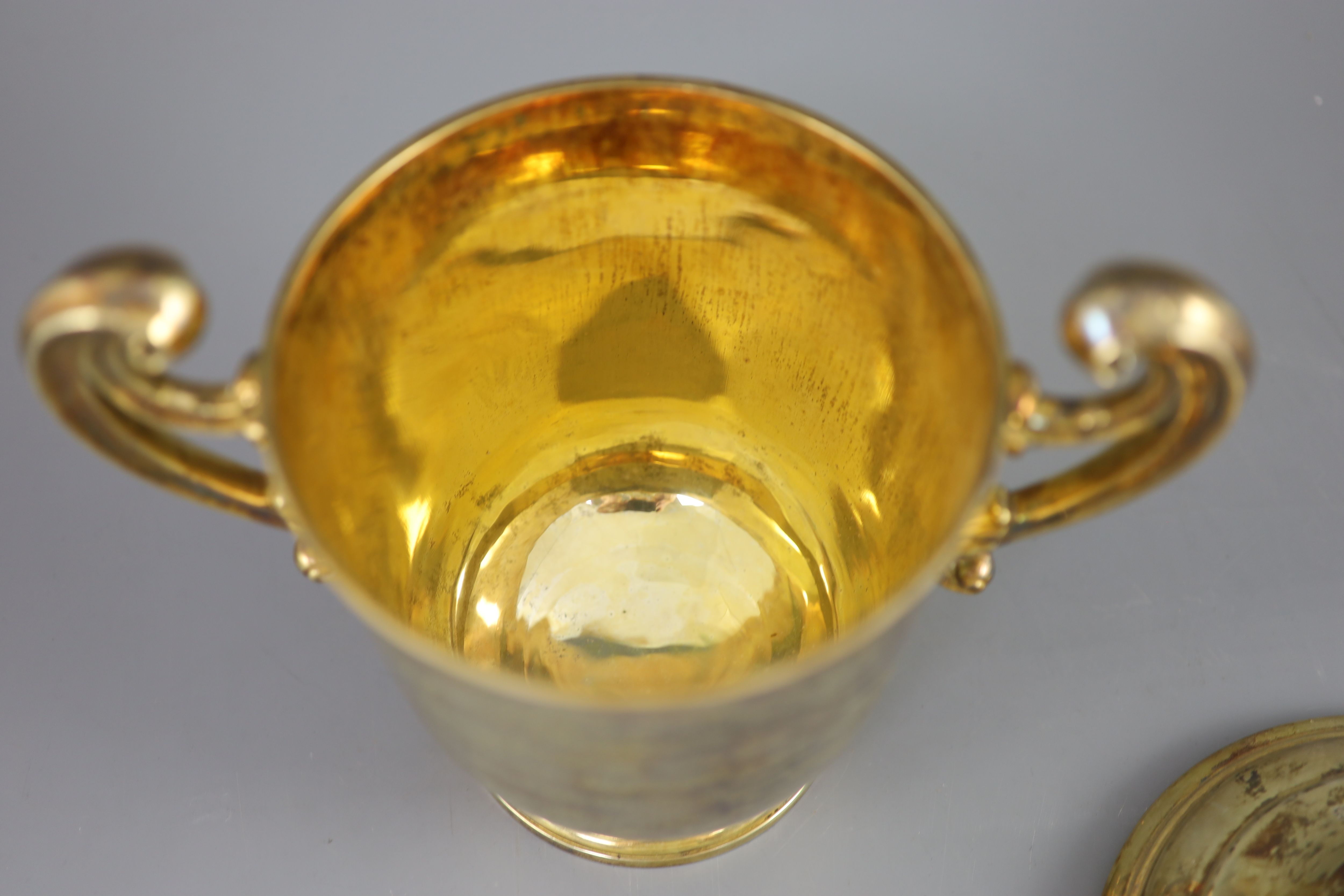 An Edwardian silver gilt-lidded two handled presentation cup and cover, by R & S Garrard and Co.